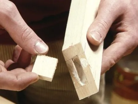 Erstellung einer Ausklinkung und schräger Schnitt am Ende eines Holzstücks.